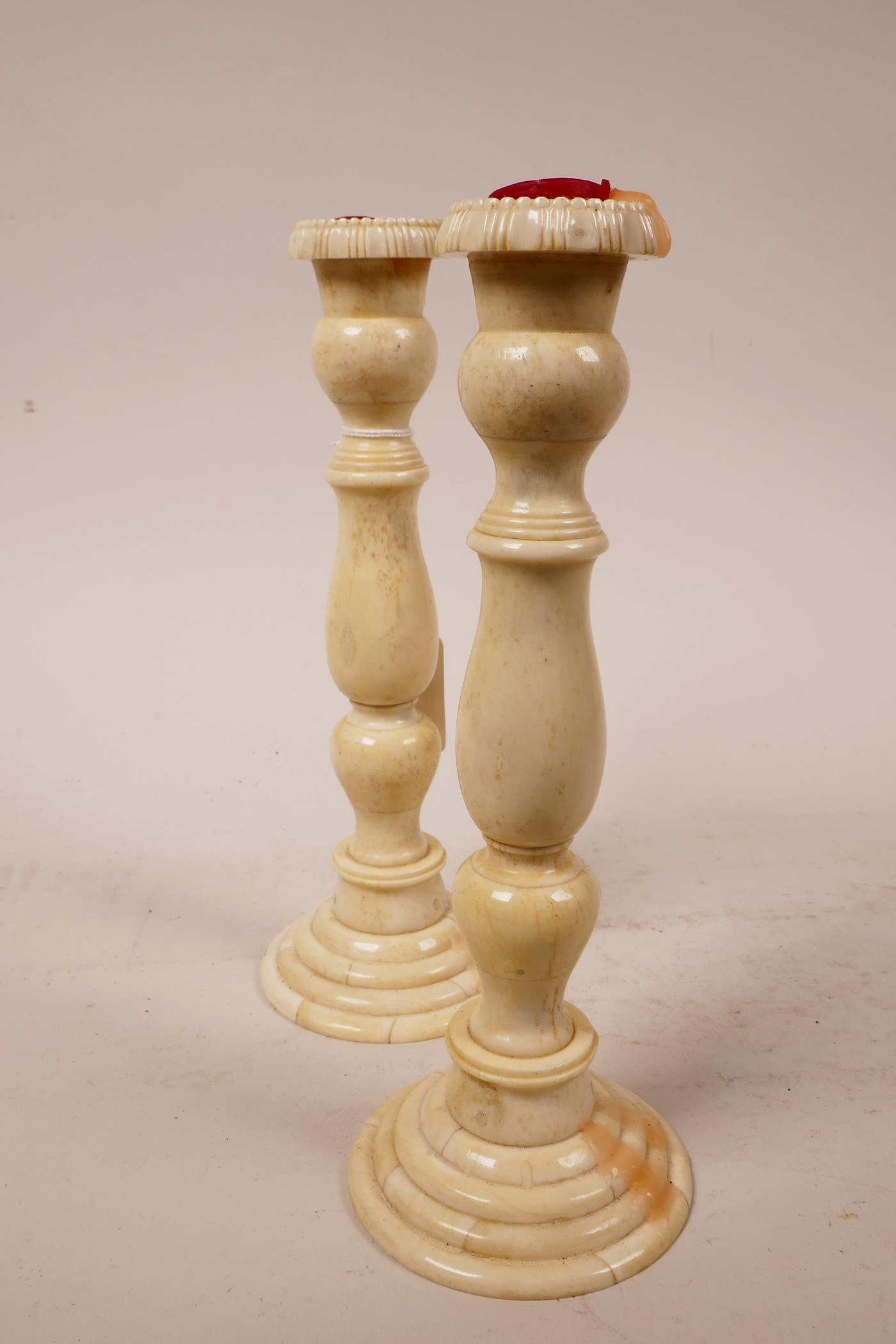 A pair of C19th bone candlesticks with turned columns, 8" high x 3" wide