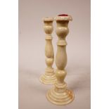 A pair of C19th bone candlesticks with turned columns, 8" high x 3" wide