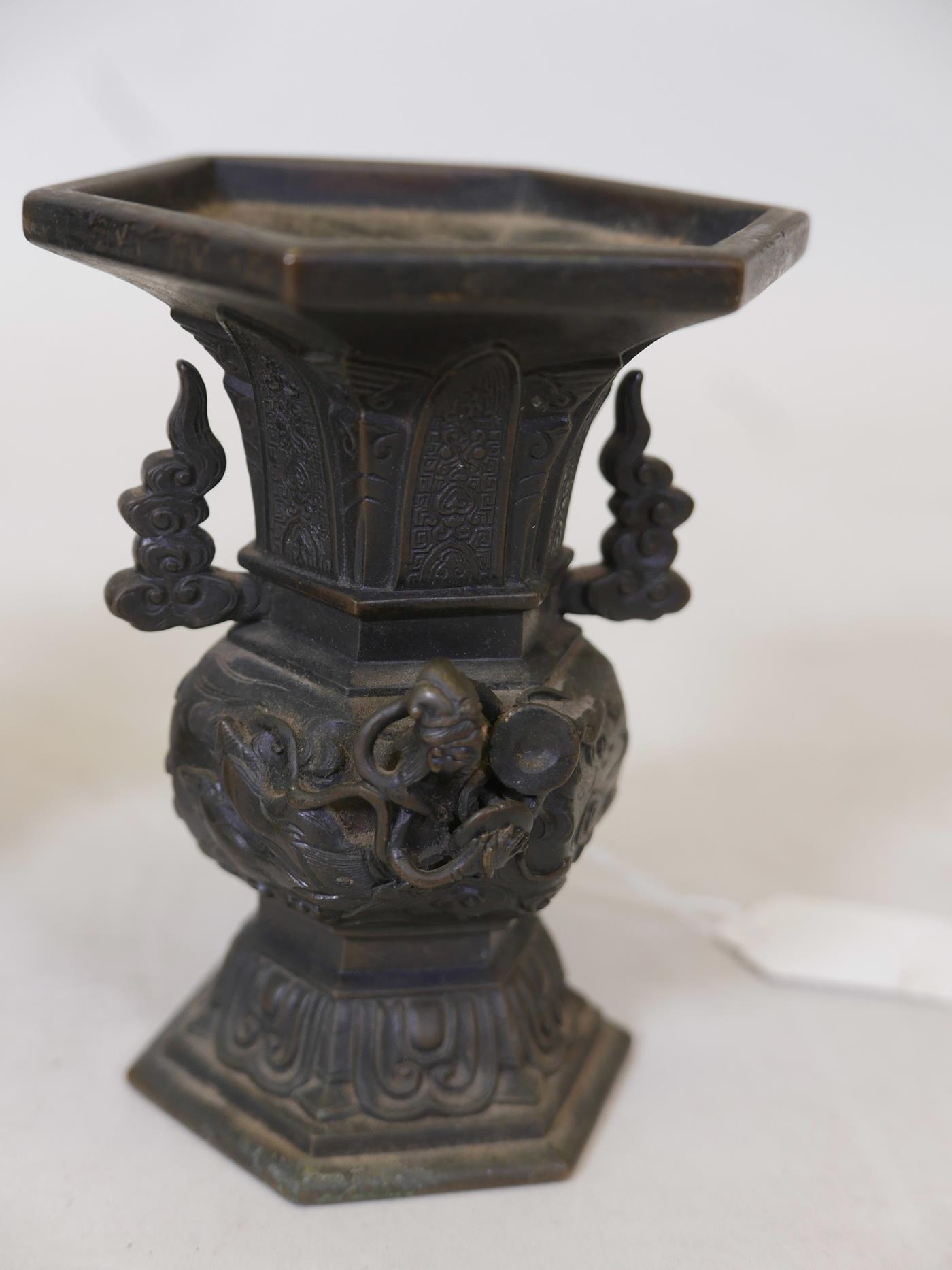 A pair of oriental bronze vases with raised decoration depicting deities flying amongst clouds, - Image 3 of 4