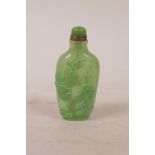 A Peking green glass snuff bottle with raised carp and crane decoration, 3" high