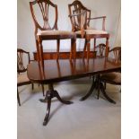A Regency style mahogany twin pedestal dining table, together with six mahogany shield back dining