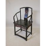 An Antique Chinese lacquered elbow chair, the splat back with carved and gilt panel, and a carved