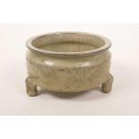 A Chinese olive green crackle glazed pottery censer on tripod supports, 5½" diameter