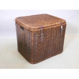 A large antique wicker laundry basket with leather straps, 28" x 23" x 23"