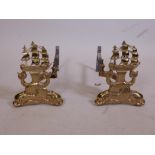 A pair of brass fire dogs in the form of HMS Victory, 18" long x 12" high