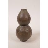 A Chinese bronzed metal double gourd vase, with raised yin yang, lotus flower and character