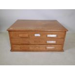 The top section of an oak plan chest, comprising three long drawers, 38" x 28" x 16"
