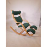 A Stokke beechwood chair with adjustable headrest