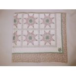 A hand stitched American patchwork quilt, early C20th, 100" x 94"