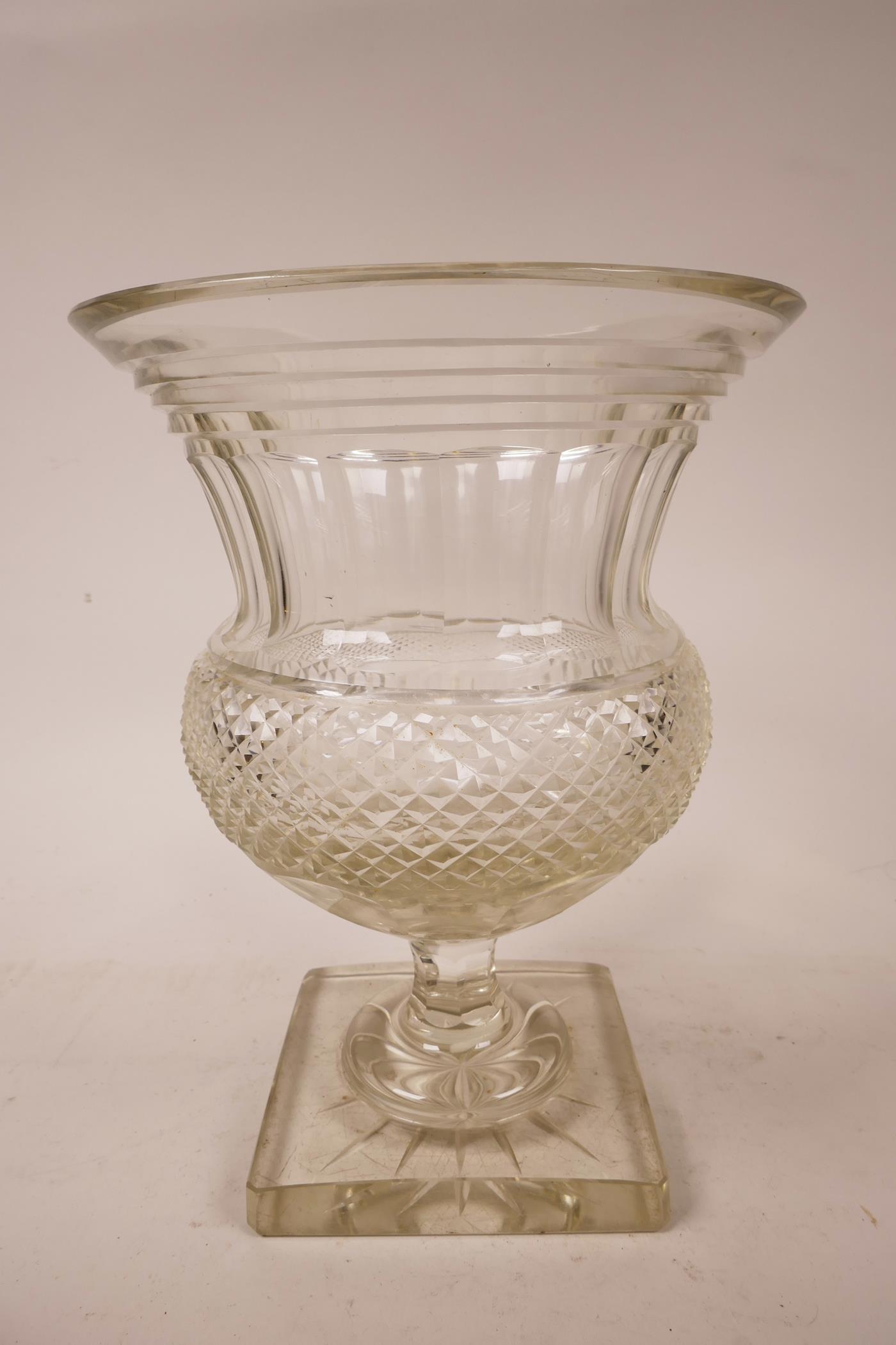 A large Georgian Anglo-Irish diamond cut, lead glass pedestal vase/urn, A starburst cut base,