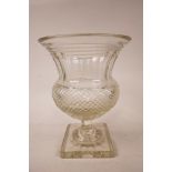 A large Georgian Anglo-Irish diamond cut, lead glass pedestal vase/urn, A starburst cut base,
