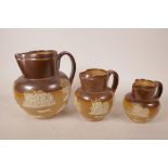 Three Royal Doulton Lambeth stoneware jugs with farming scenes, circa 1905, various sizes, largest
