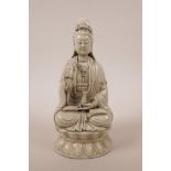 A Chinese blanc de chine figure of Quan Yin seated on a lotus throne, 10"h
