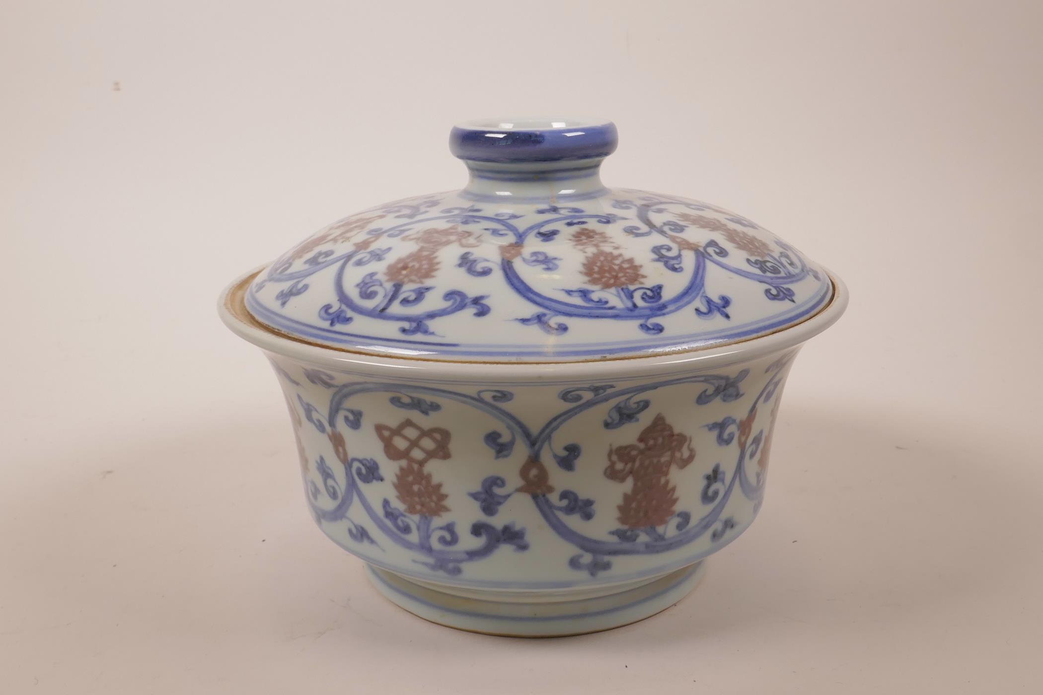 A Chinese blue, white and red porcelain pot and cover decorated with lotus flowers and the emblems - Image 4 of 7