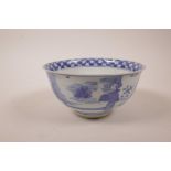 A Chinese blue and white porcelain rice bowl decorated with figures in a garden, six character