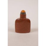 A Chinese goldstone snuff bottle, 2½" high