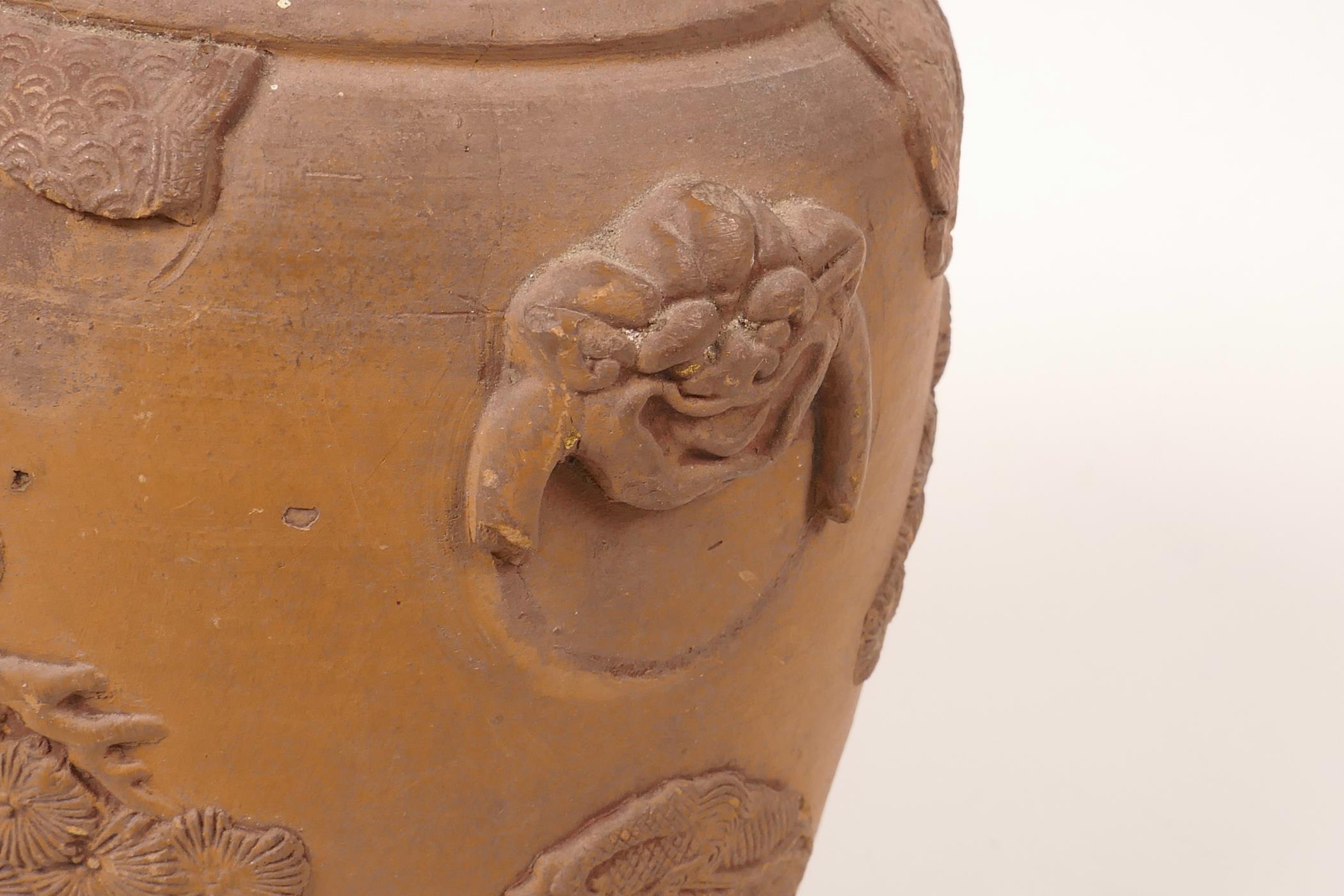 A Chinese earthenware jar with raised decoration of a figure and dragon, A/F losses and chips, 7" - Image 5 of 7