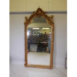 A French style gilt wood and composition wall mirror, the top flanked by two putti, some losses, 44"