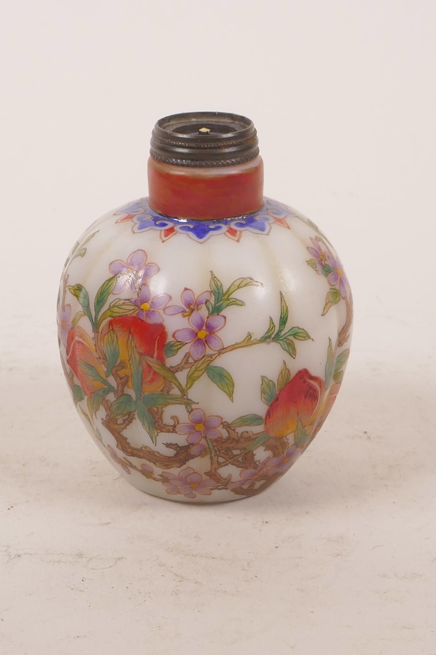 A Chinese enamelled glass snuff bottle in the form of a gourd, decorated with a fruiting peach tree,