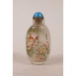 A Chinese reverse decorated glass snuff bottle depicting birds amongst branches in bloom, 3½" high