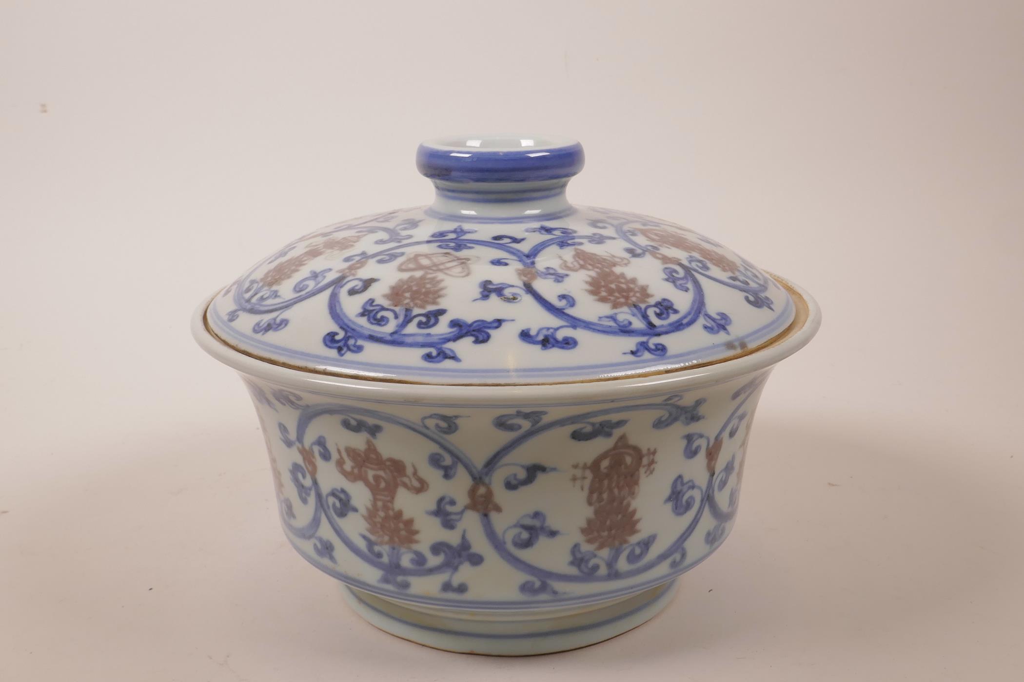A Chinese blue, white and red porcelain pot and cover decorated with lotus flowers and the emblems - Image 2 of 7