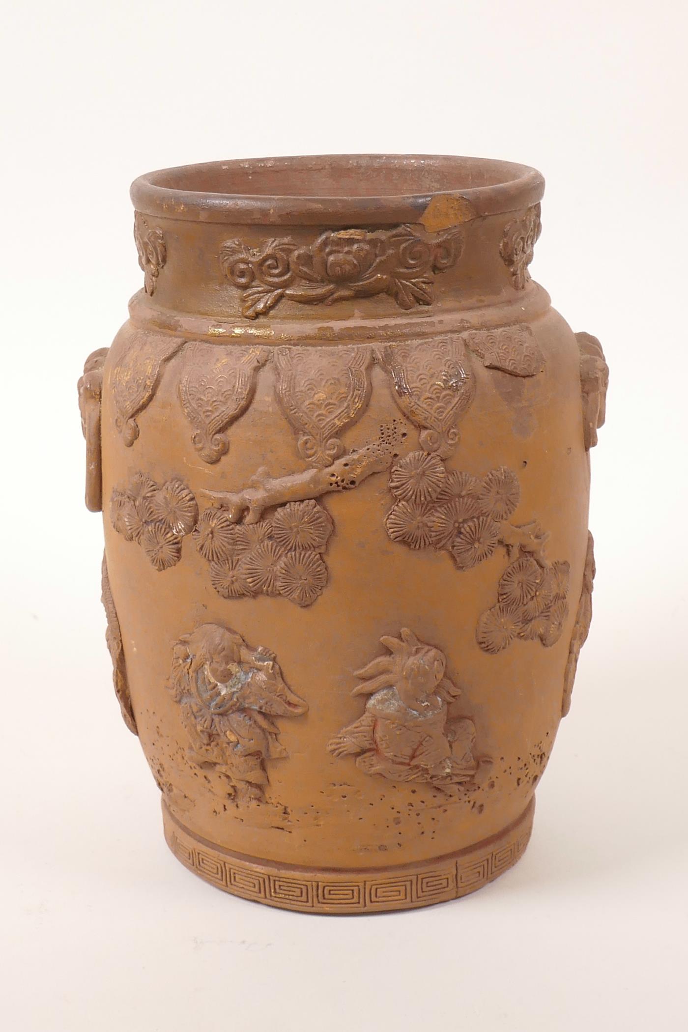 A Chinese earthenware jar with raised decoration of a figure and dragon, A/F losses and chips, 7"
