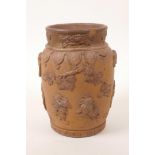 A Chinese earthenware jar with raised decoration of a figure and dragon, A/F losses and chips, 7"