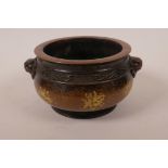 A Chinese bronze censer with two mask handles and gilt patina, impressed six character mark to base,