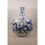 A Chinese blue and white porcelain moon flask decorated with a dragon in flight, six character