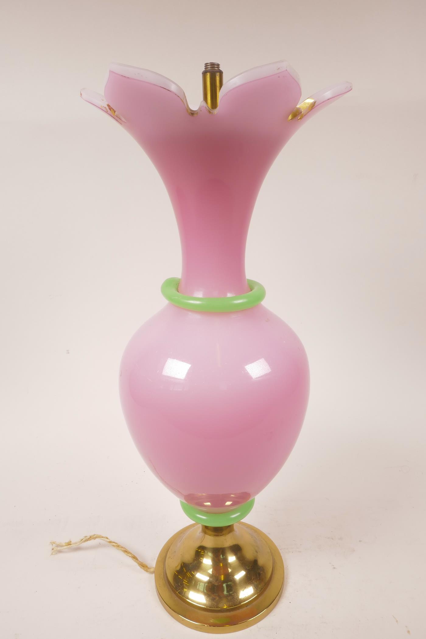 An opaline glass lamp with pink body and green trim, on a brass base (WF), 16" high x 6" wide