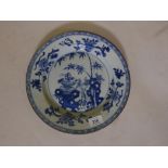 A C19th Chinese blue and white plate with bamboo and floral decoration, A/F chips to rim, and 2"