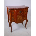 A French two drawer shaped front commode with exotic wood veneers, instrument and floral inlaid