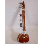 A vintage sitar with bone inlaid decoration, A/F, 47" long