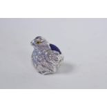 A miniature sterling silver pin cushion in the form of a chicken with blue glass eyes, 1" high
