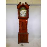 A C19th mahogany long case clock, with shaped door and turned columns, raised on a shaped base,
