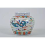 A Chinese doucai porcelain ginger jar and cover, decorated with dragons chasing the flaming pearl,