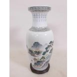 A Chinese Republic porcelain vase decorated with figures in a forest and lake landscape, calligraphy