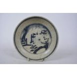 A Chinese blue and white pottery dish decorated with figures in a garden, 6 character mark to