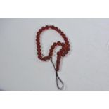 A string of cherry amber style Islamic prayer beads, 17" long