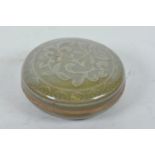 A Chinese Song style olive glazed pottery box and cover with raised floral decoration, 4½" diameter