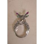 A 925 silver magnifying glass pendant, the handle formed as a fairy with stone set wings