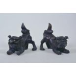 A pair of Oriental patinated bronze figures of fo dogs, 6" long