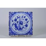 A Chinese blue and white porcelain tile decorated with flowers, 8" x 8"