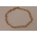 A 9ct gold fancy link bracelet with safety chain, 8" long, 6.4 grams