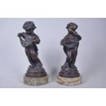 A pair of classical bronzes of children carrying fruit and birds, 13" high