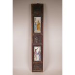 A Chinese carved wooden wall panel containing two ceramic tiles painted with figures and