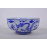 A Chinese blue and white porcelain bowl decorated with dragons chasing the flaming pearl, 6