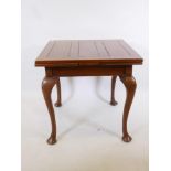 A Queen Anne style walnut drawleaf dining table, raised on cabriole supports, 30" x 30" x 54"