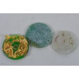 A collection of three Chinese hardstone pendants decorated with auspicious symbols, a Chinese