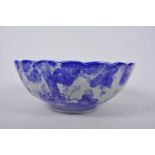 A Chinese blue and white porcelain bowl of ribbed design decorated with many figures, A/F chip to